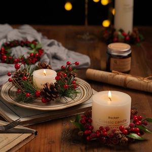Christmas pine wreath candle holder with red berries and lighted white pillar candles