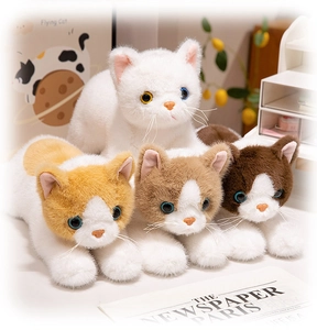 Detailed view of lifelike plush cat family with soft fur and vivid eyes on a white table