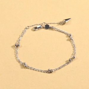 Detail of S925 sterling silver double layer chain bracelet with bead and cone pendant