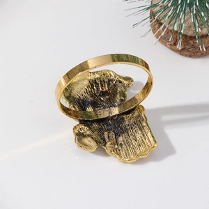 Detailed view of an elegant golden elephant napkin ring with vintage metal texture