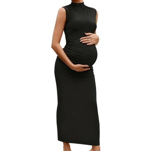 Detail of black maternity maxi dress featuring elegant side ruching and stretchy knit fabric