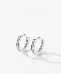 Detail of S925 sterling silver hoop earrings with channel-set baguette cubic zirconia