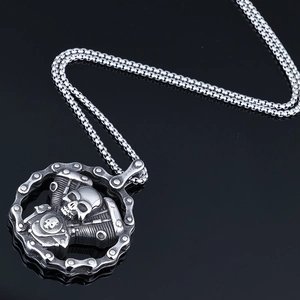 Detailed punk skull pendant with engine and gear chain elements on black background