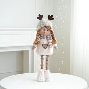 Close-up of plush long-legged Christmas doll on a white table with cozy festive lighting