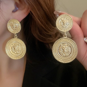 Vintage gold lion head relief drop earrings with geometric round metallic design