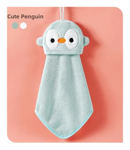 Detail of penguin-shaped hanging hand towel in mint coral velvet with soft texture