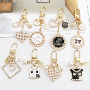 Detail of luxury style alloy charms including number 5 and heart shapes on golden rings