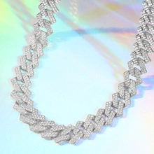 Close-up of silver Cuban link necklace with pavé-set shimmering zircon stones
