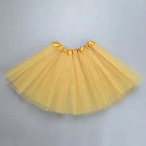 Detailed view of layered yellow mesh tulle fabric and satin waistband on the tutu skirt