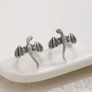 Vintage silver flying dragon ear cuff with detailed dragon scale texture and gothic style