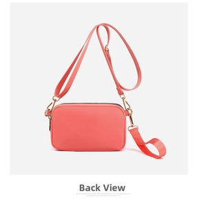 Back view of the peach pink PU leather crossbody bag showing smooth texture and gold hooks