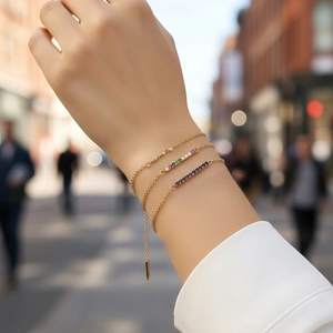 Chic gold chain bracelet set with colorful zircons worn by model on a city street