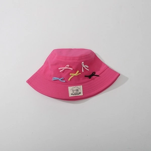 Pink cotton sun hat for girls with colorful mini bows and a central patch detail