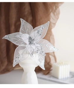 Close-up of a silver glitter mesh decorative flower on a pedestal for Christmas decor
