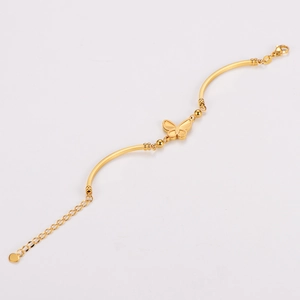 Golden butterfly bracelet with curved tube design and adjustable chain on white background