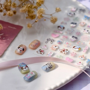 Cute dog nail art stickers with pink hearts and bows for DIY manicure decoration