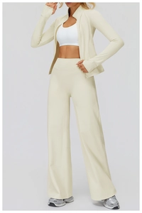 Detail of high-waist wide-leg thermal pants and zippered jacket in cream white beige