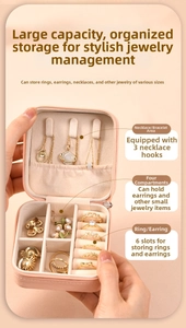 Pink portable jewelry box detail showing necklace hooks and ring slots compartments