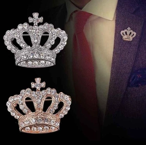 Detailed comparison of silver and rose gold crown brooches with model styling on suit