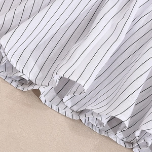 Close-up of black and white striped dress fabric showing high-quality cotton linen texture