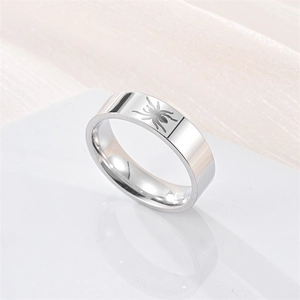 Detail of silver titanium steel ring featuring a clear engraved spider web pattern