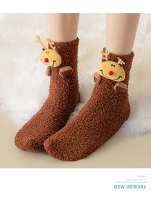 Detail of coral fleece Christmas sock featuring 3D reindeer doll and soft plush texture