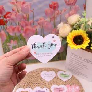 Close-up of heart-shaped paper thank you card for small business jewelry packaging