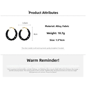 Detailed view of 4cm C-shaped hoop earrings with black fabric and white polka dots