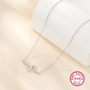 Macro detail of S925 sterling silver snake pendant with sparkling white cubic zirconia