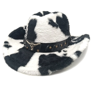 Detail of plush cow print cowboy hat with black leather band and metal bull head emblem