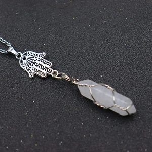 Detail of Hamsa Hand charm and wire-wrapped pink crystal hexagonal pillar pendant