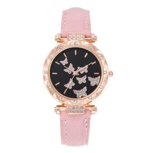 Detail of rose gold watch case with sparkling crystal butterfly motifs on a black dial