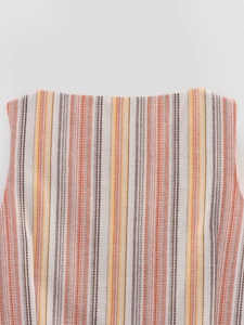 Close-up of rainbow striped sleeveless vest showing woven cotton texture and neck detail