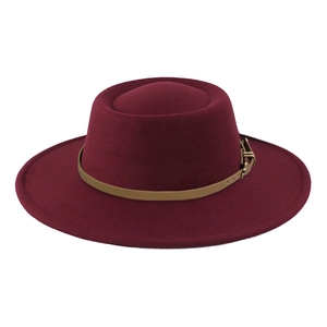 Detail of burgundy wool fedora hat featuring a brown leather band and metallic buckle