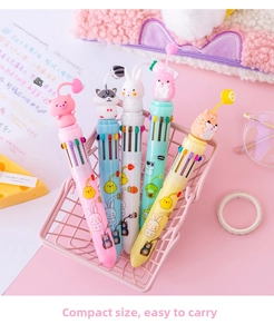 Close-up of five colorful cartoon pens with 3D animal toppers in a pink decorative basket