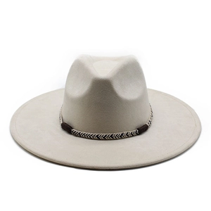 Macro detail of beige suede fedora featuring a woven geometric hat band design