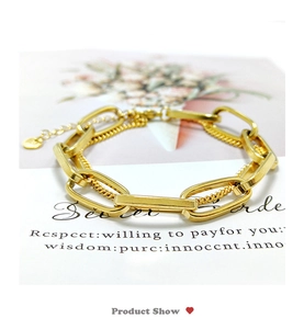 Detail of gold titanium double-layer chunky chain bracelet with logo charm and clasp