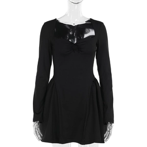 Detail of black long-sleeve dress with sweetheart neckline and ruched flared skirt hem
