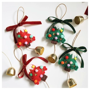 Detail of wool felt Christmas tree ornaments with velvet bows and golden bells