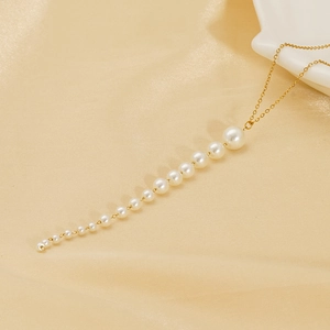 Collier à pampilles en perles dorées avec dégradé sur fond de soie élégante