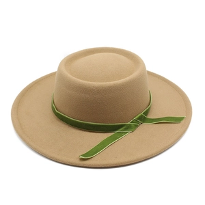 Top view of a camel wool felt boater hat with a dark green velvet decorative band