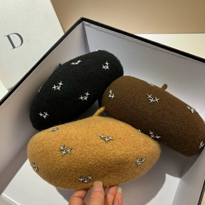 Detailed top view of wool berets with rhinestone stars in black, brown and camel colors