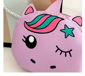 Close-up of pink PU leather unicorn bag showing fine texture and star print details