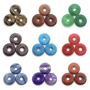 Macro display of nine colorful natural agate donuts with gold plating and unique textures