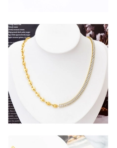 Detail of gold-plated collar necklace featuring zirconia stones and pig nose chain