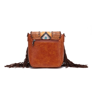 Detailed view of bohemian crossbody bag with floral embossing, fringes, and rear zipper