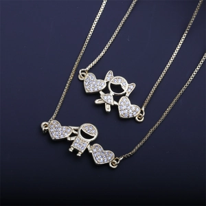 Gold necklace charms featuring boy and girl figures with sparkling cubic zirconia pavé