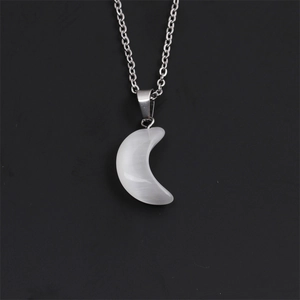 Close-up of a silver twisted chain necklace with a translucent crescent moon pendant