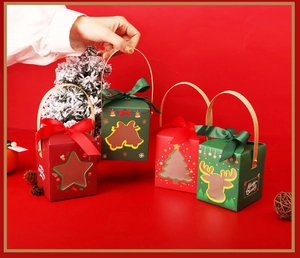 Detail of red and green Christmas gift boxes with Merry Christmas motifs and silk bows