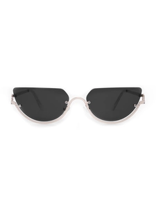Detailed view of dark lenses and rose gold metal semi-rimless frames on cat eye sunglasses